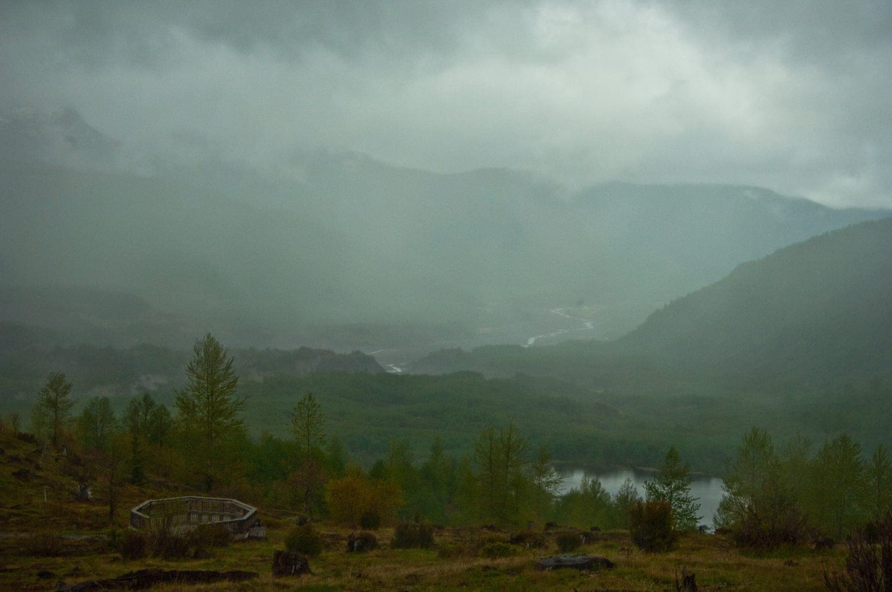 Fog moving through a forested river valley